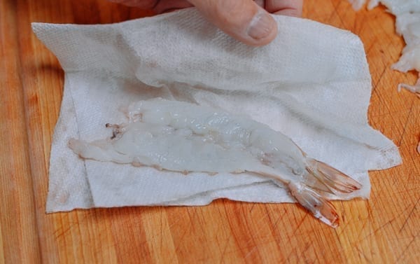 Patting shrimp dry with paper towel, thewoksoflife.com