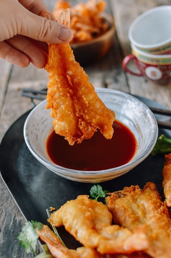 Dipping fantail fried shrimp into sauce, thewoksoflife.com
