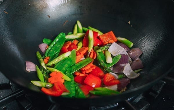 Adding blanched vegetables back to wok, thewoksoflife.com