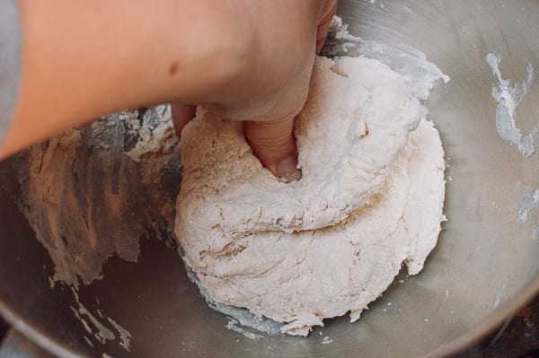 Pushing dough together with hands, thewoksoflife.com