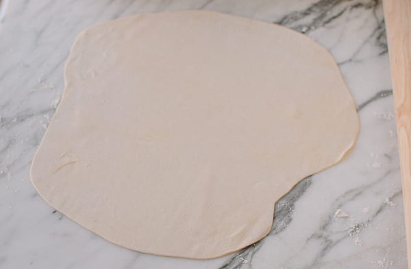 Rolling dough out into thin sheet, thewoksoflife.com