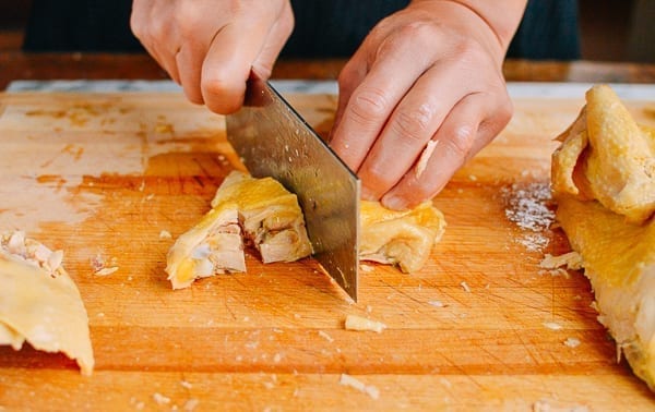 Cutting chicken thigh into small pieces, Chinese-style, thewoksoflife.com