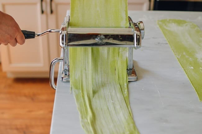 Cutting spinach noodles with pasta cutter, thewoksoflife.com