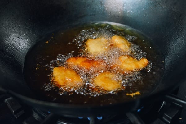 Batter fried chicken pieces in wok, thewoksoflife.com