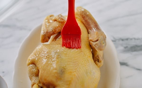 Brushing poached chicken with oil, thewoksoflife.com
