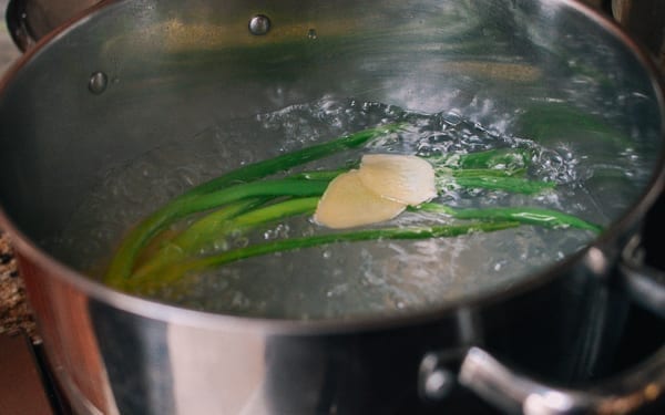 Boiling water with scallions and ginger, thewoksoflife.com