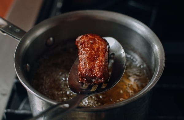 Pulling fried rib out of frying oil, thewoksoflife.com