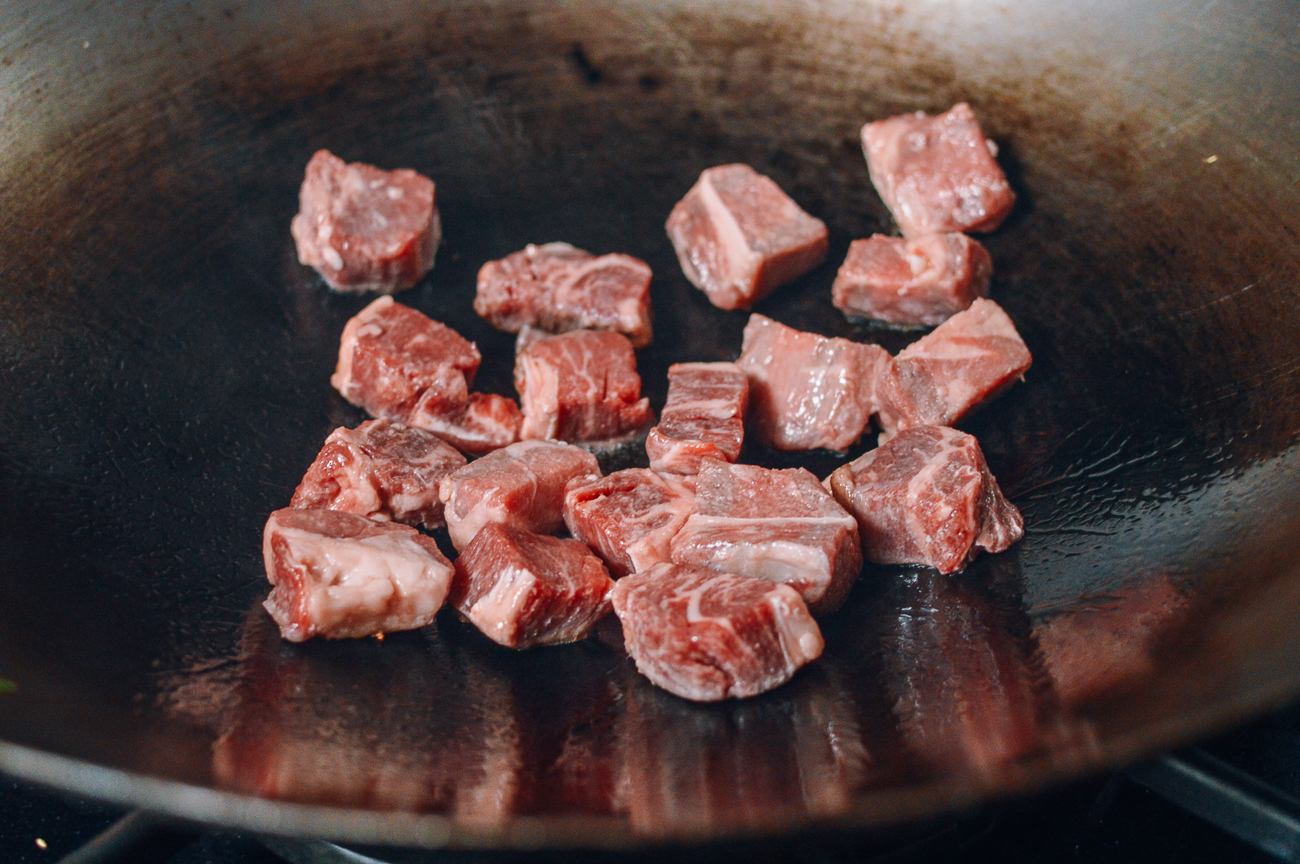 chunks of steak in wok
