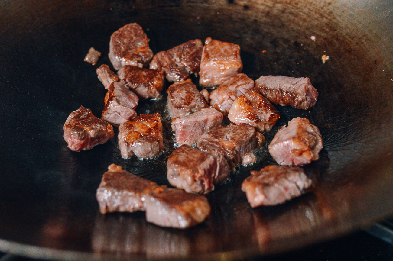 searing steak chunks in wok