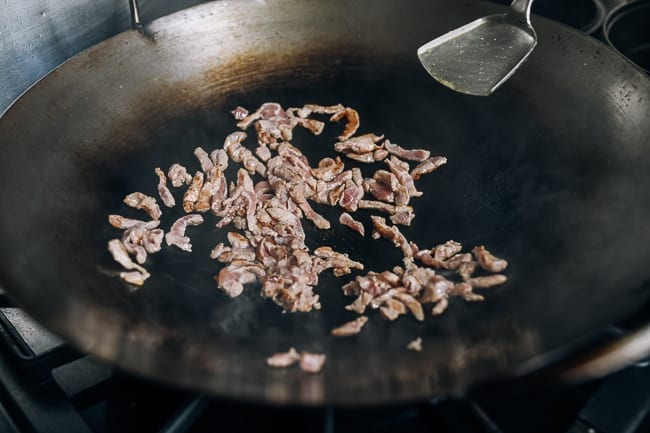 searing julienned pork in wok
