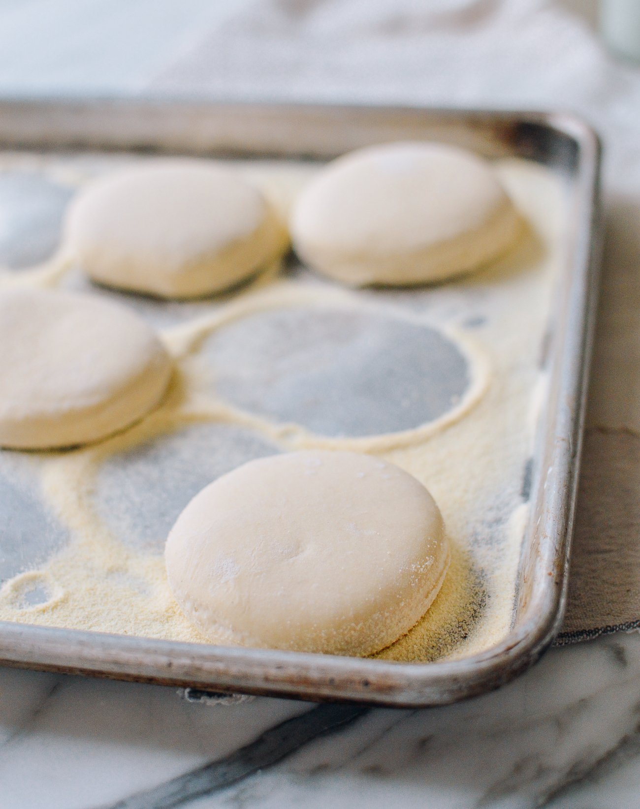 English muffins on sheet pan before cooking