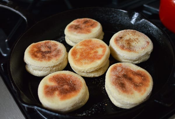 Cooking English muffins in cast iron skillet, thewoksoflife.com
