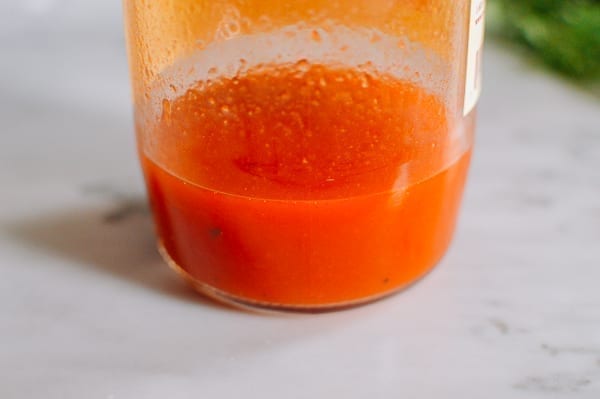 Cleaning out tomato sauce jar with water, thewoksoflife.com