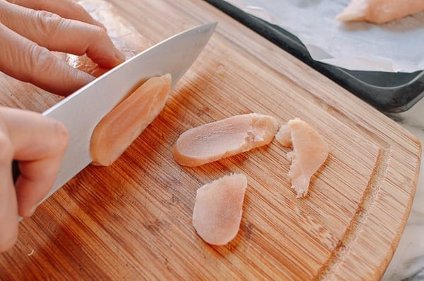 Slicing partially frozen chicken breast, thewoksoflife.com