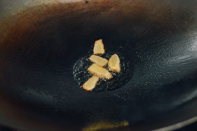 Cooking ginger in oil in wok, thewoksoflife.com