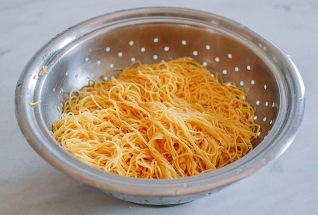 Draining noodles in colander, thewoksoflife.com