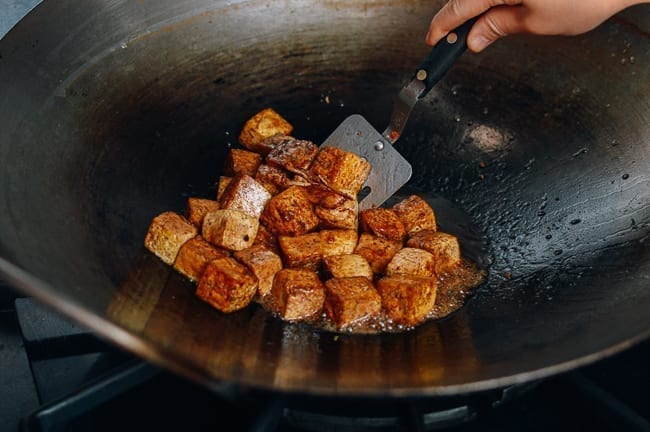 Stirring tofu in sauce, thewoksoflife.com