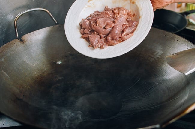 Adding pork to wok, thewoksoflife.com