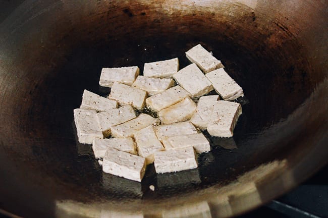 Browning tofu in wok, thewoksoflife.com