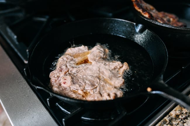 Frying pork chops in cast iron skillet, thewoksoflife.com