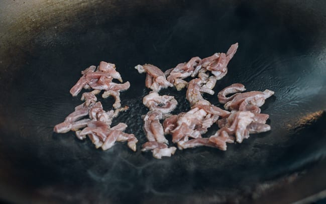 Stir-frying shredded pork in wok, thewoksoflife.com