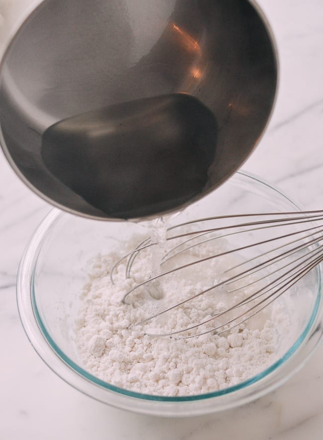 Adding hot sugar water to rice flour water mixture, thewoksoflife.com