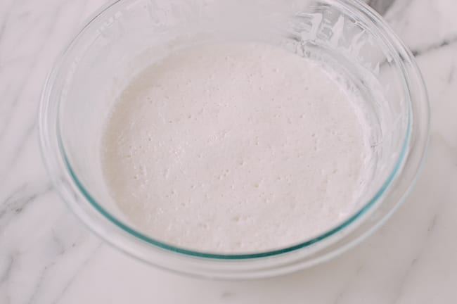 Bubbles on fermented rice flour, sugar, water, and yeast mixture, thewoksoflife.com