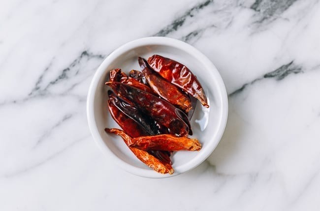 dried red chili peppers in small white dish