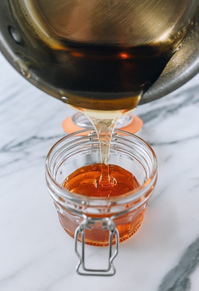 Pouring warm golden syrup into heatproof airtight container, thewoksoflife.com