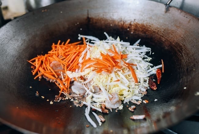 Adding carrots and napa cabbage to wok, thewoksoflife.com