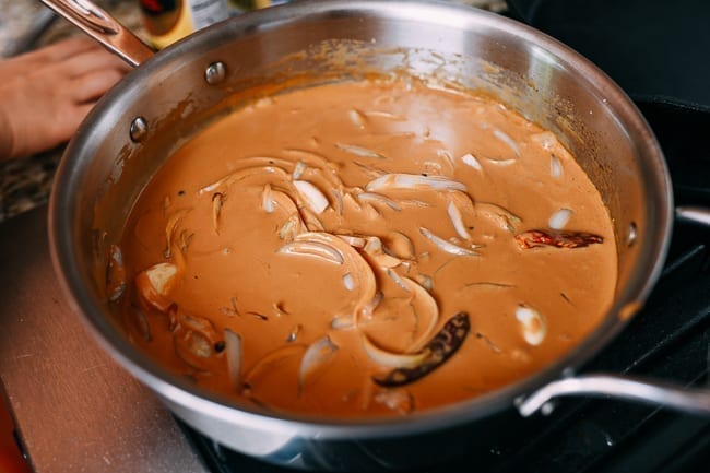 Simmering adobo sauce with coconut milk, thewoksoflife.com
