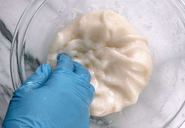 Kneading mochi dough with gloved hands, thewoksoflife.com