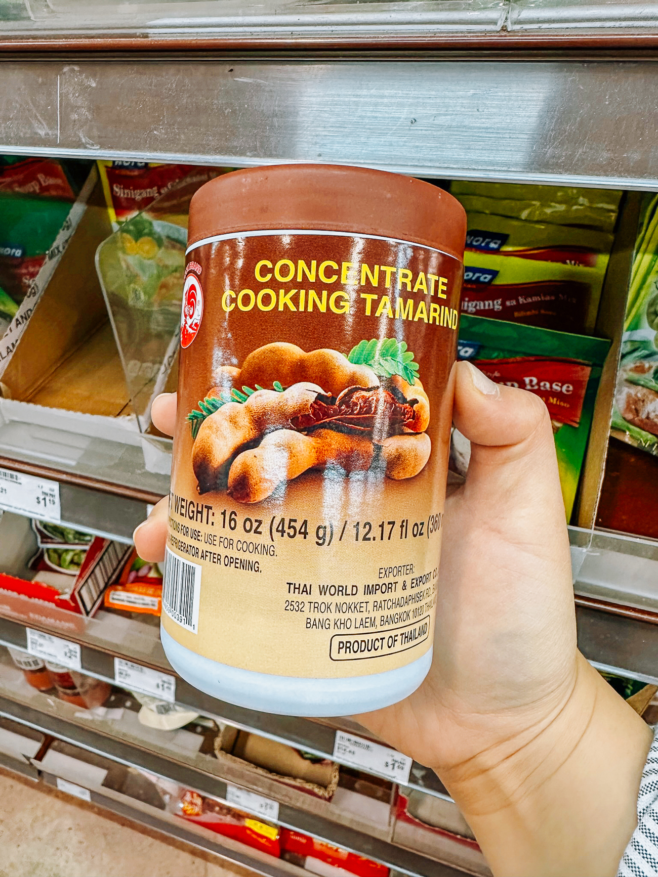 holding jar of tamarind concentrate in Asian grocery