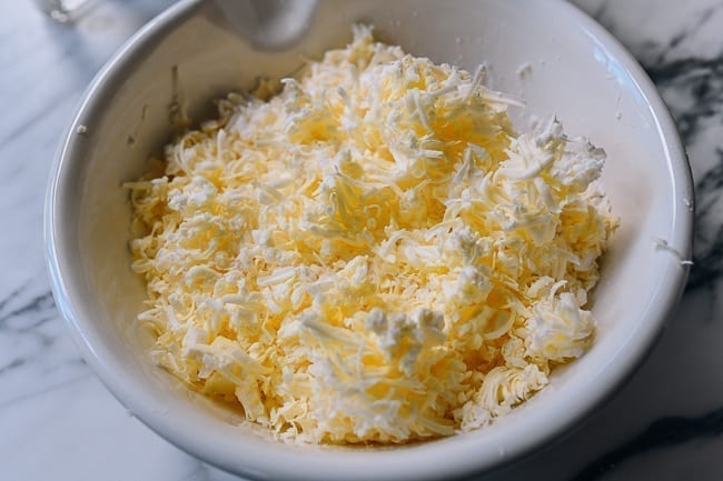 Flour and grated butter in mixing bowl, thewoksoflife.com