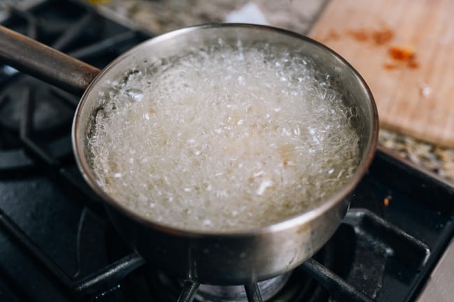 Oil bubbling around frying noodles