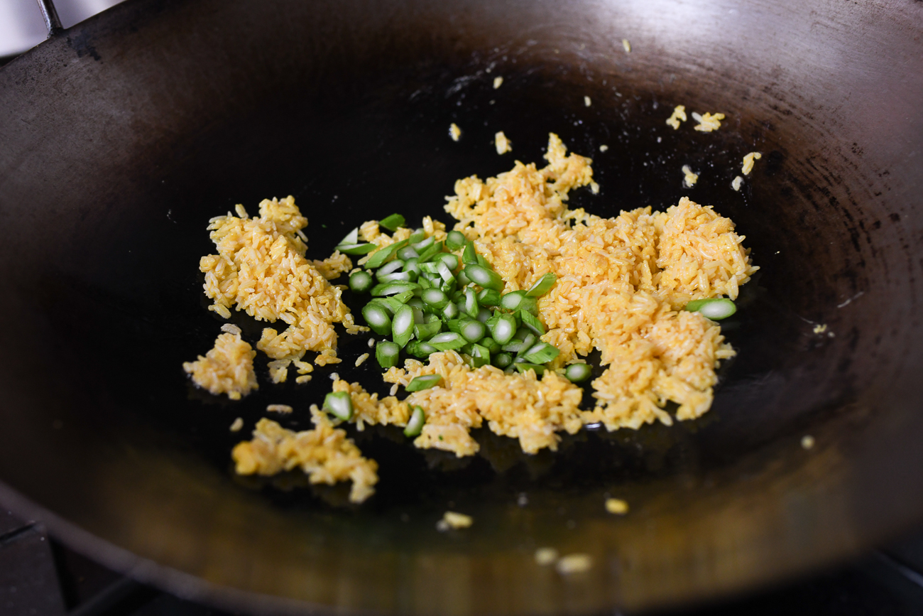 Adding choy sum stems to fried rice