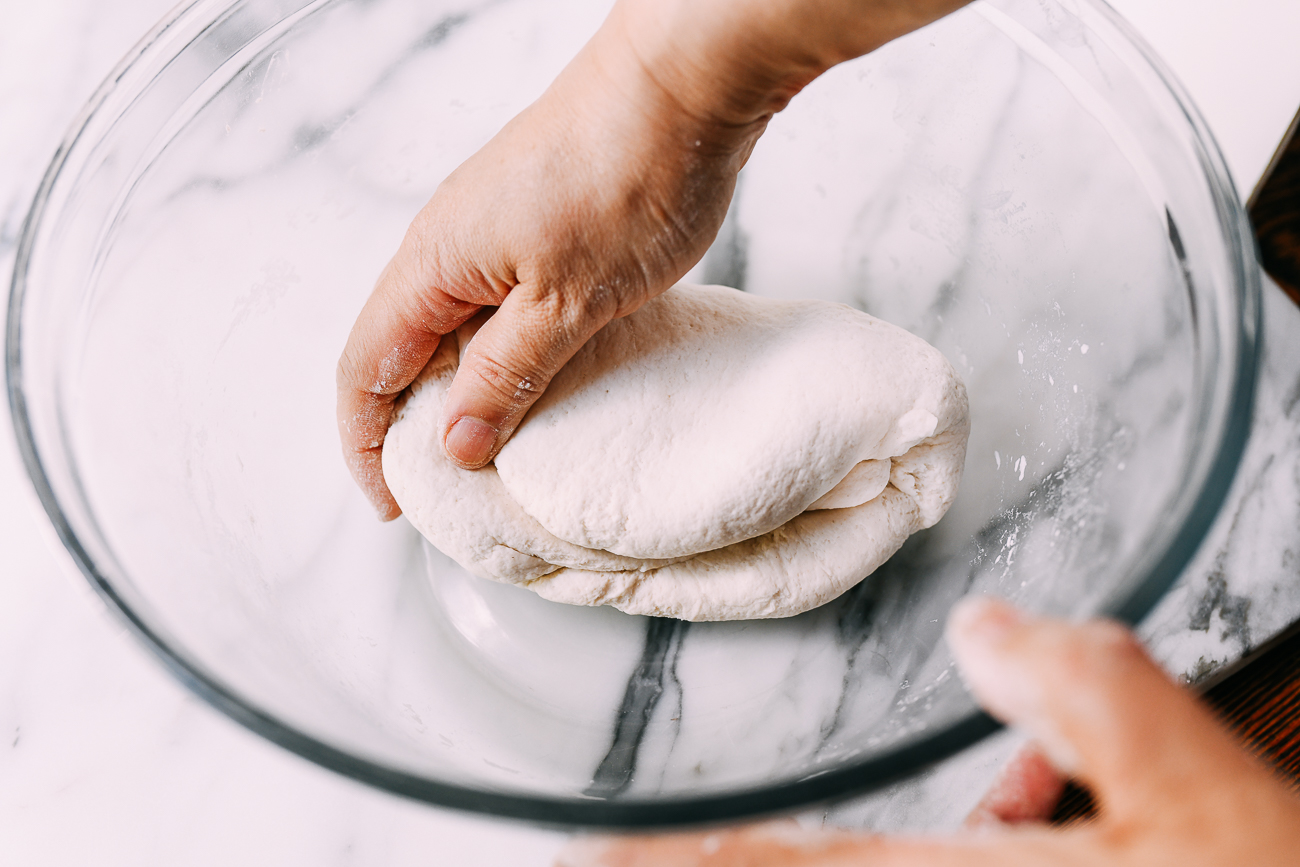 Hand-kneading shengjian bao dough, thewoksoflife.com