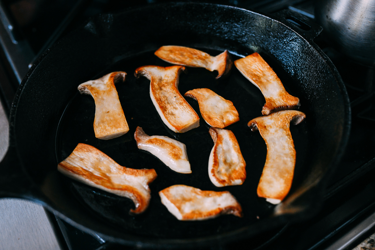 Pan-frying slices of king oyster mushrooms