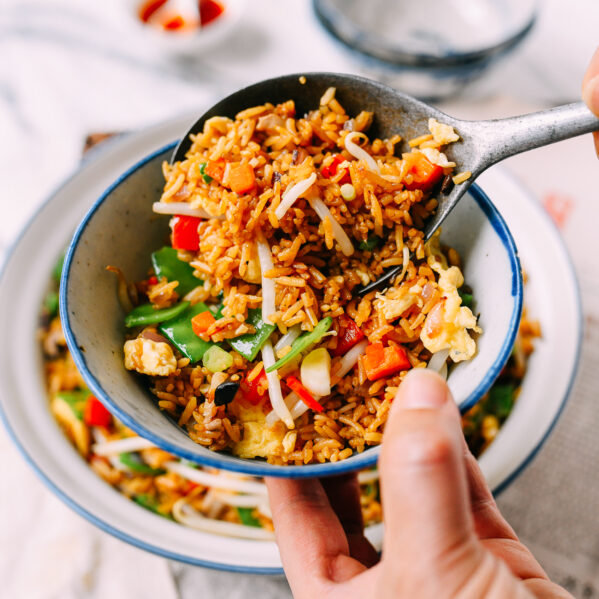 Scooping Vegetable Fried Rice Into Bowl