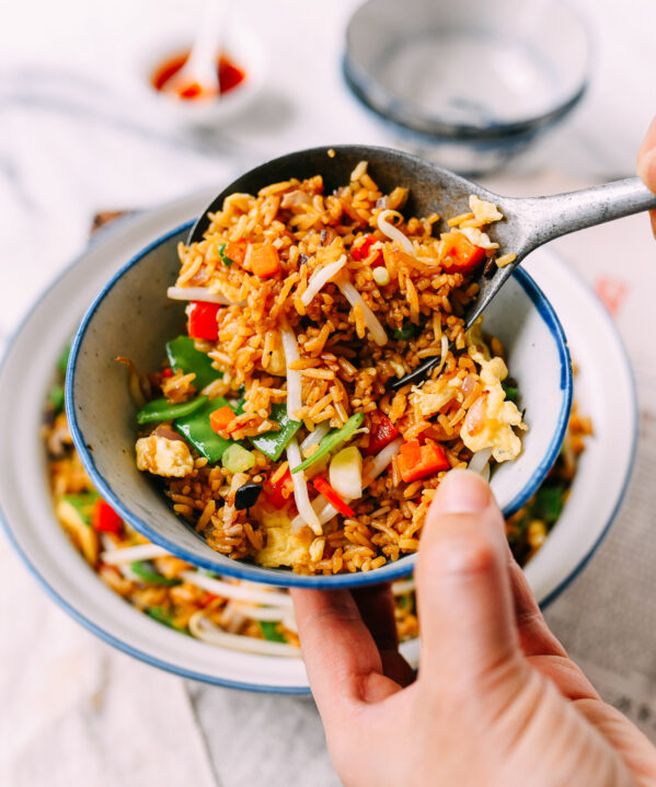 Scooping Vegetable Fried Rice Into Bowl