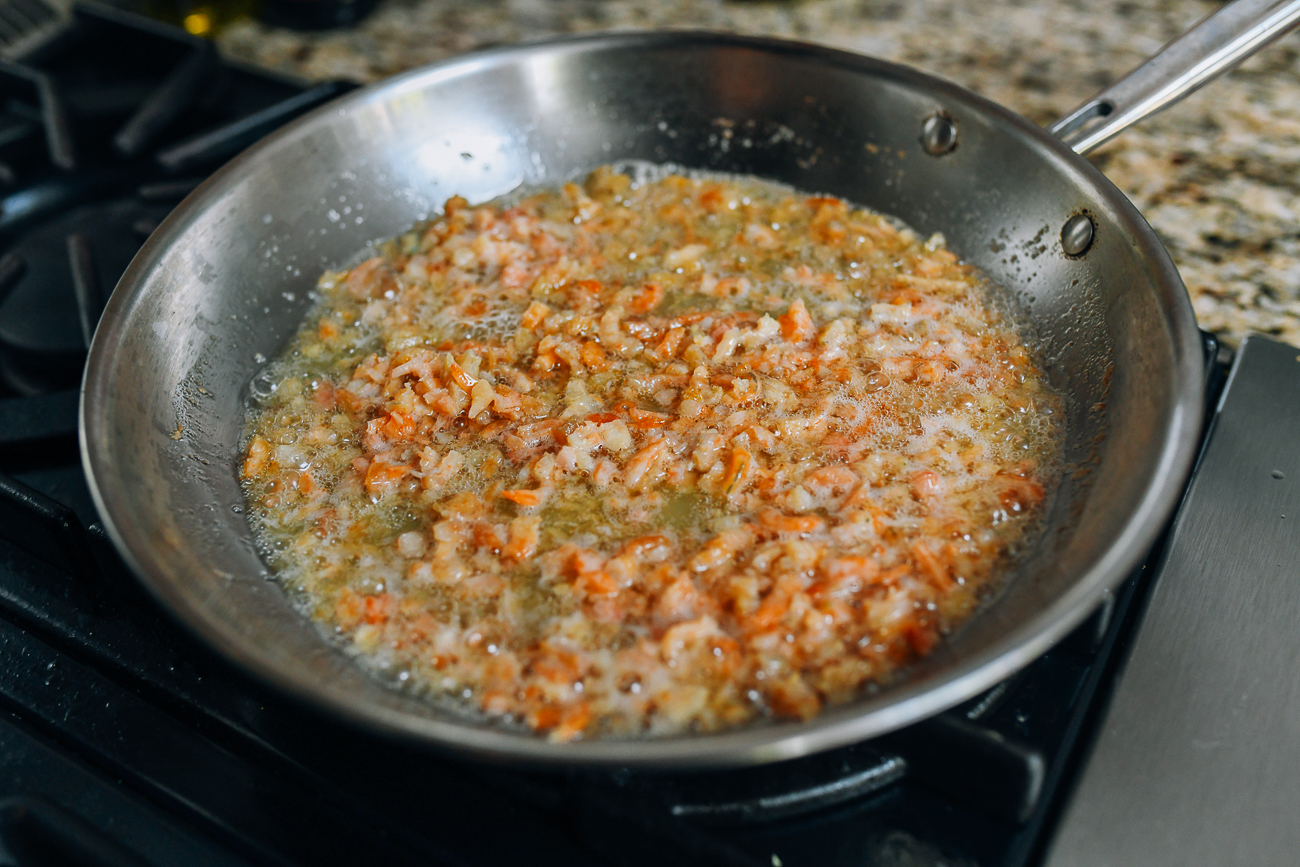 Frying chopped dried shrimp in pan with oil