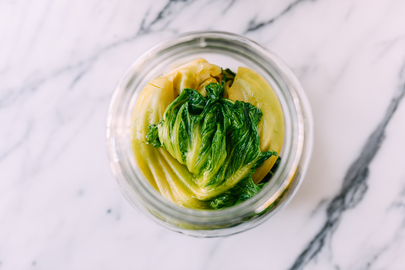 Brined mustard greens in glass jar