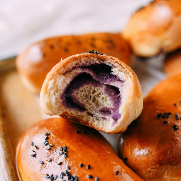 Ube bun with a bite taken out of it