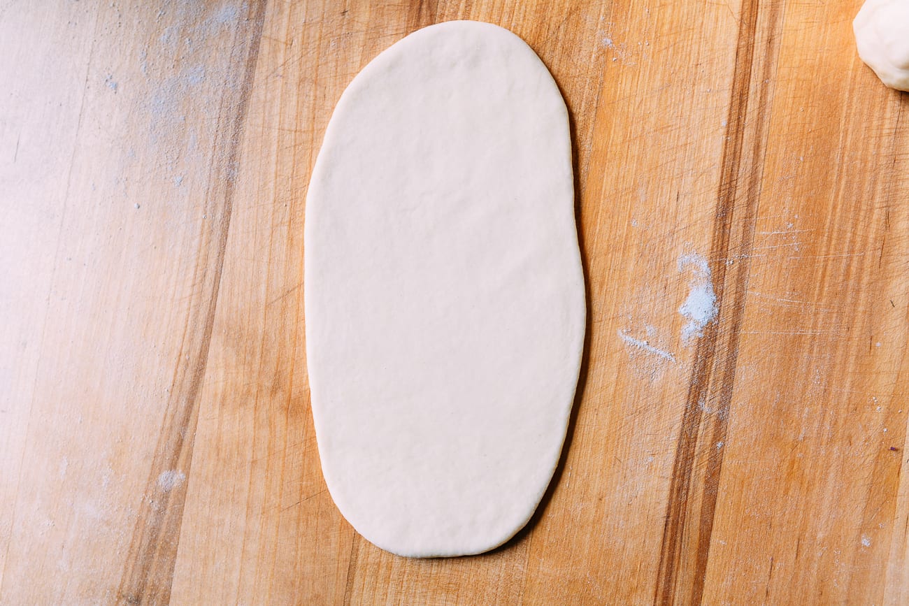 Milk bread dough rolled into an oval/rectangle