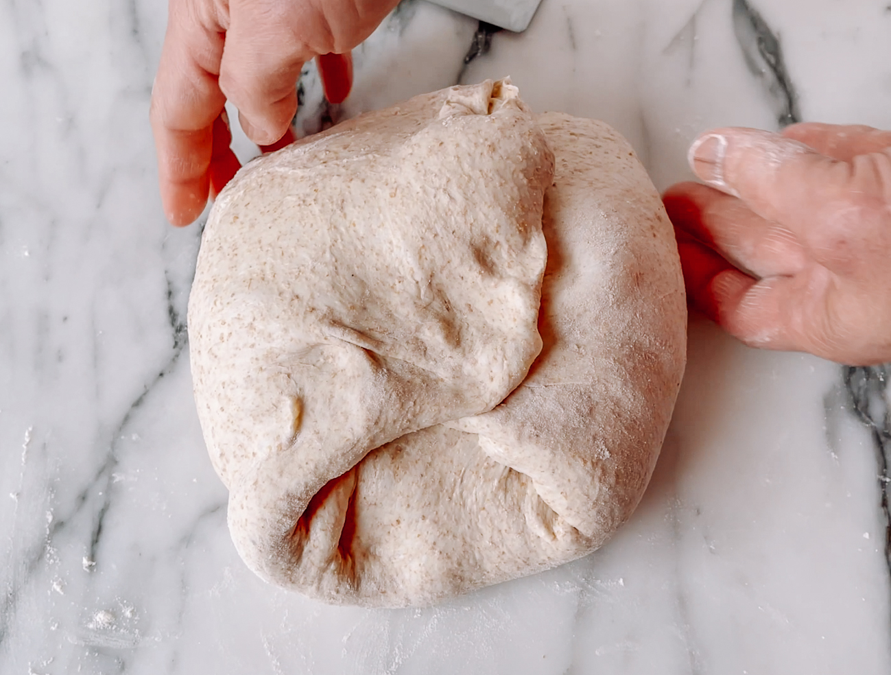 Folding sides of dough into center