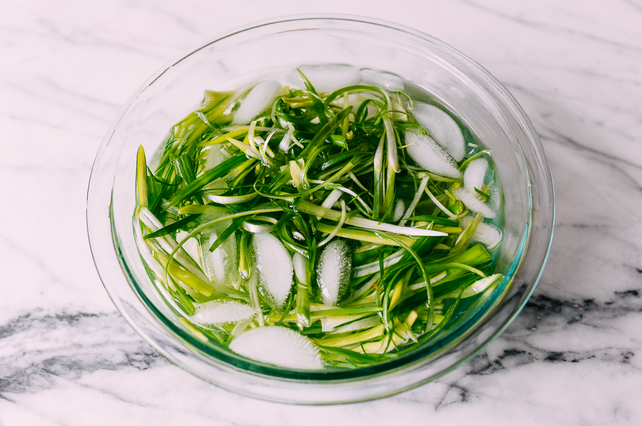 julienned scallions in ice water