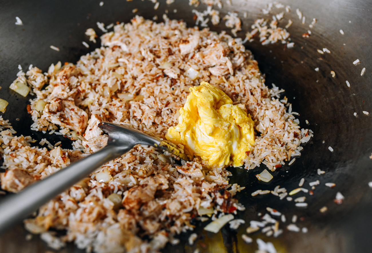Adding eggs to cooked rice