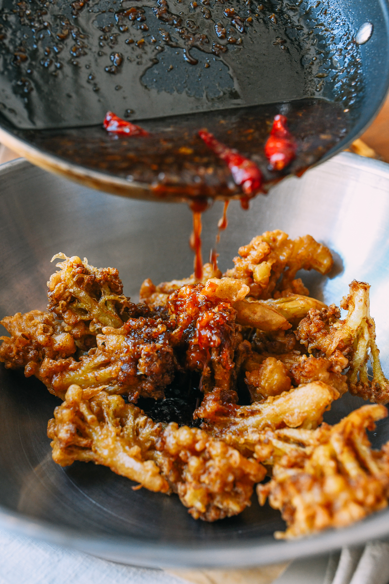 Pouring sauce over fried cauliflower