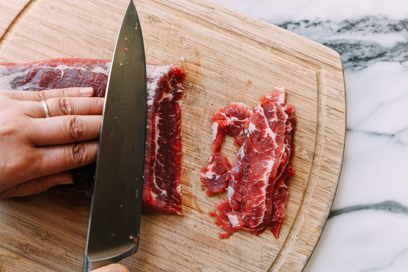 thinly slicing flank steak against the grain