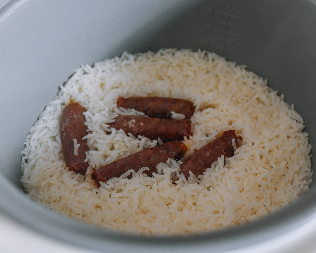 Steamed rice and Chinese sausage in rice cooker pot